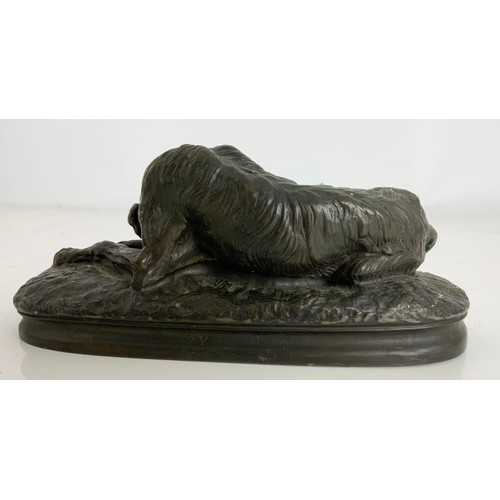 287 - A COMPOSITE BRONZE MODEL OF A RECUMBENT WOLF HOUND, SIGNED M DEVA WIDTH 15CM