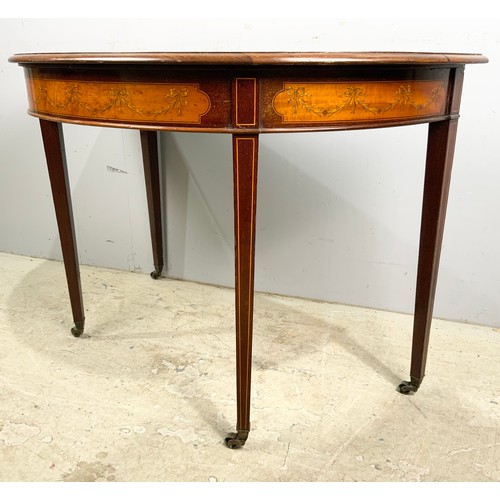 553 - MAHOGANY D END SIDE TABLE WITH INLAID SWAG  & RIBBON DECORATION ON BRASS CASTERS  WIDTH 107cm