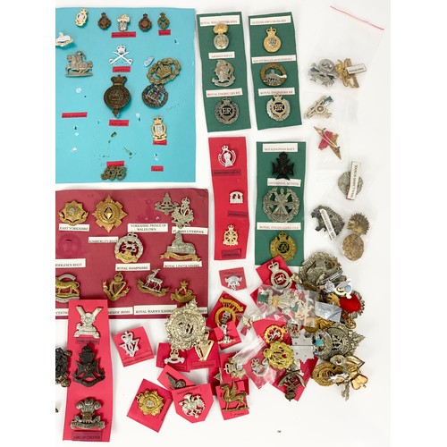 83 - LARGE COLLECTION OF MILITARY CAP BADGES ETC. MANY APPEAR TO BE REPLICAS BUT WELL WORTH A CAREFUL SOR... 