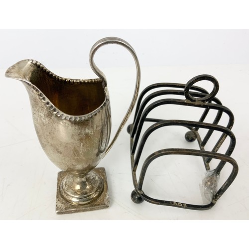 234 - HALLMARKED SILVER 5 BAR TOAST RACK AF & HELMET SHAPED CREAM JUG WITH REPAIR  154g