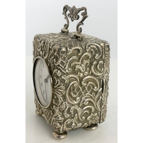 312 - A VICTORIAN SILVER DESK TIME PIECE WITH EMBOSSED SILVER CASE