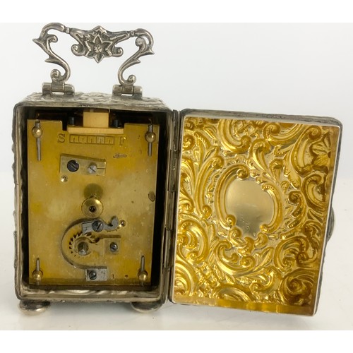 312 - A VICTORIAN SILVER DESK TIME PIECE WITH EMBOSSED SILVER CASE