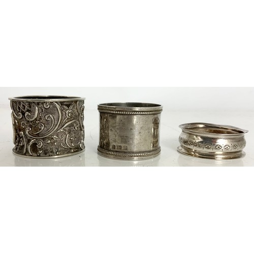 154 - THREE VARIOUS SILVER SERVIETTE RINGS, APPROXIMATELY 64g