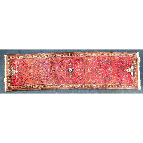 702 - A PERSIAN RUNNER. Approx. 270 x 80cm