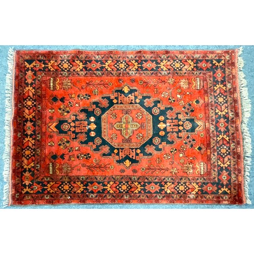 703 - AN AFGHAN RED GROUND RUG. 155 X 103cm Approx.