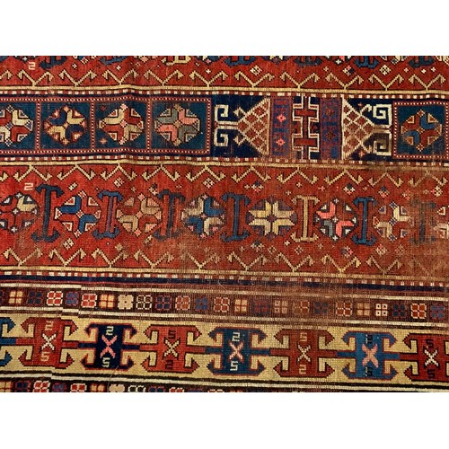 688 - RED GROUND RUG WITH GEOMETRIC PATTERN 275cm x131cm