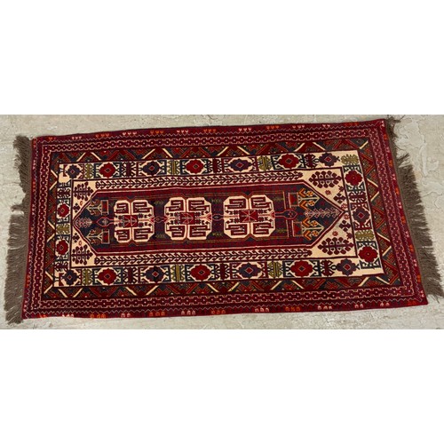 690 - RED GROUND RUG WITH GEOMETRIC PATTERN 185cm x 97cm