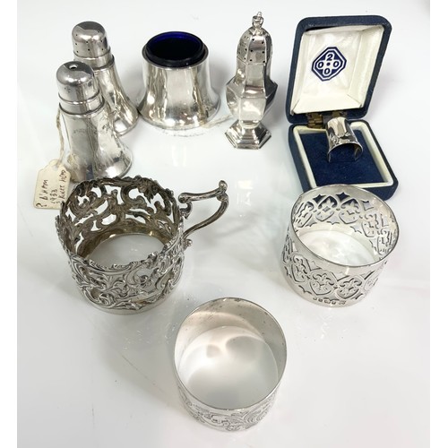 157 - HALLMARKED SILVER INC 2 BOTTLE COASTERS, CRUETS, SERVIETTE RINGS, CASED THIMBLE ETC