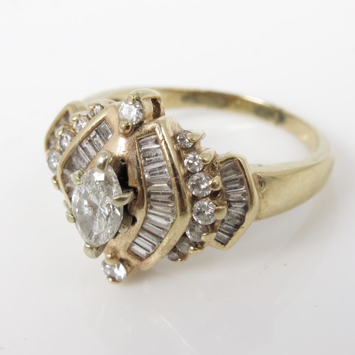 677 - AN IMPRESSIVE DIAMOND CLUSTER RING WITH A CENTRAL MARQUISE CUT STONE IN A SETTING WITH BAGUETTE AND ... 