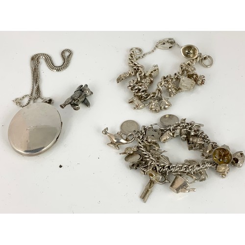 555 - 2 SILVER CHARM BRACLETS WITH MULTIPLE CHARMS, LARGE LOCKET WITH CHAIN AND A SILVER ARTICULATED BEAR ... 