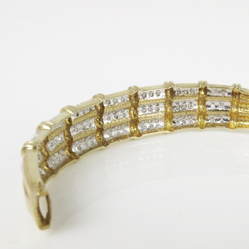 574 - 9CT GOLD AND WHITE STONE HINGED BANGLE