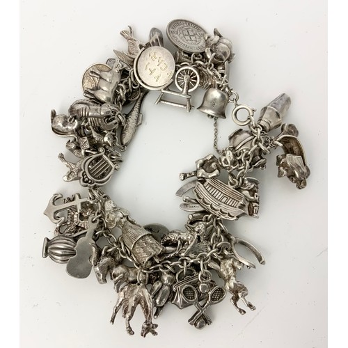 562 - MIXED SILVER & WHITE METAL JEWELLERY INC  HEAVY SILVER CHARM BRACELET WITH MANY CHARMS