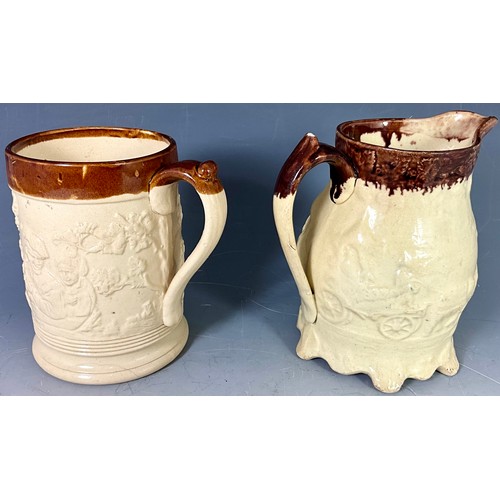 205 - CREAM GLAZED RELIEF DECORATED STONEWARE TANKARD AND JUG