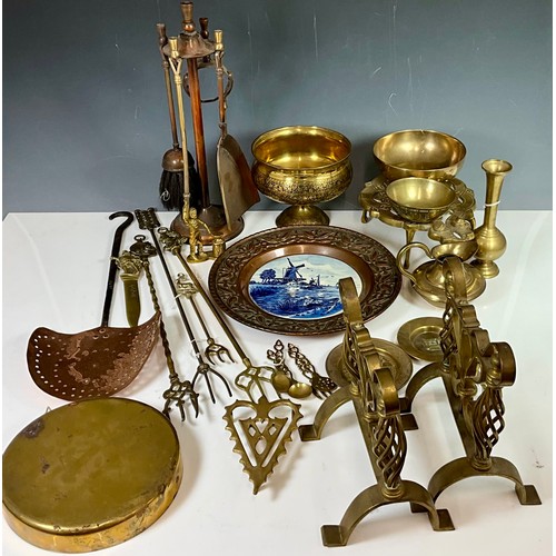 328 - COPPER AND BRASS WARE INC. FIRE DOGS, A GONG, COMPANION SET, A CHESTNUT ROASTER, BOWLS, A CHARGER AN... 