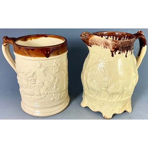 212 - CREAM GLAZED RELIEF DECORATED STONEWARE TANKARD AND JUG