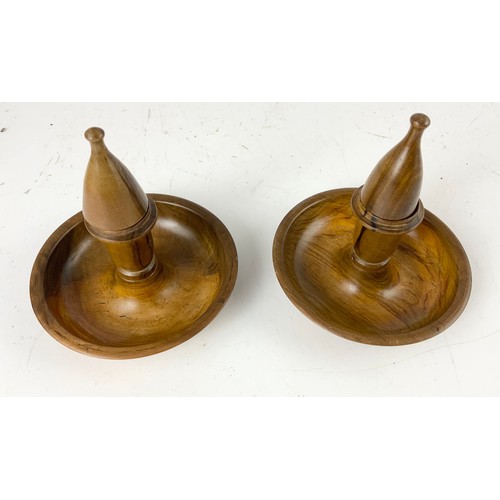 308 - TWO ARTILLERY SHELL DOOR STOPS AND AN OLIVE WOOD TRAVELLING CANDLESTICK