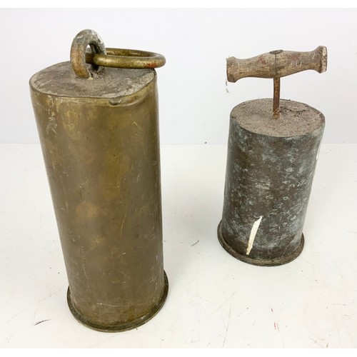 308 - TWO ARTILLERY SHELL DOOR STOPS AND AN OLIVE WOOD TRAVELLING CANDLESTICK