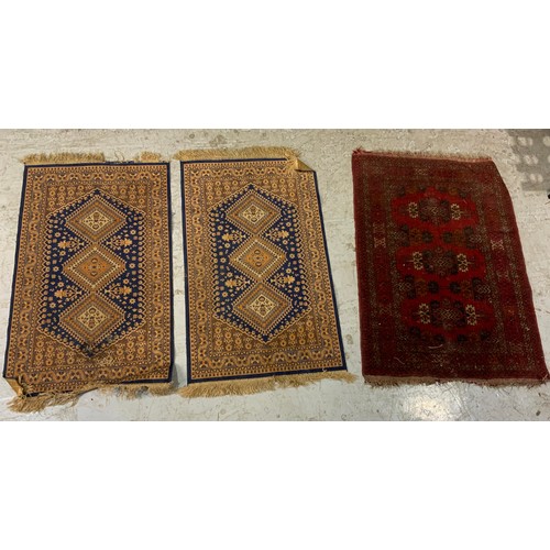 737 - PAIR OF BLUE GROUND RUGS 112cm x 69cm & A RED GROUND RUG 119cm x 83cm