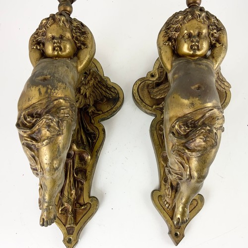 295 - PAIR OF METAL WALL LIGHT FITTINGS MODELLED AS CHERUBS WITH GLASS FLAME SHAPED SHADES