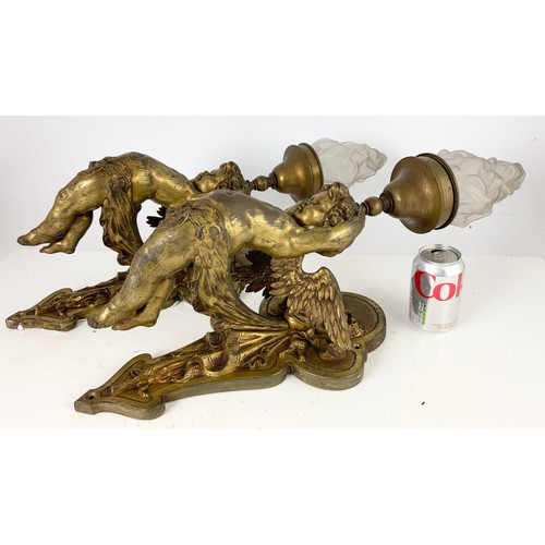 295 - PAIR OF METAL WALL LIGHT FITTINGS MODELLED AS CHERUBS WITH GLASS FLAME SHAPED SHADES