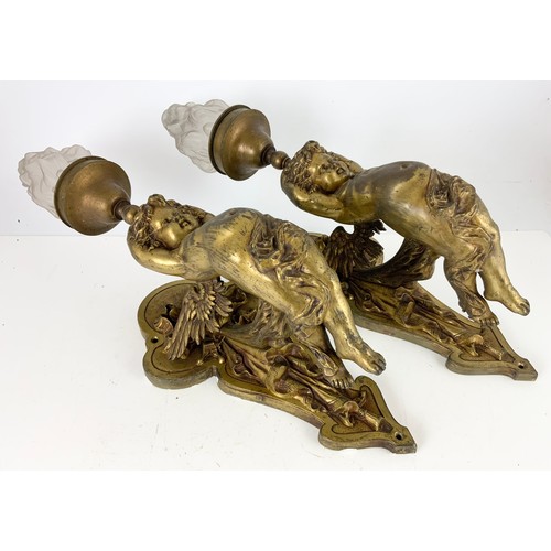 295 - PAIR OF METAL WALL LIGHT FITTINGS MODELLED AS CHERUBS WITH GLASS FLAME SHAPED SHADES