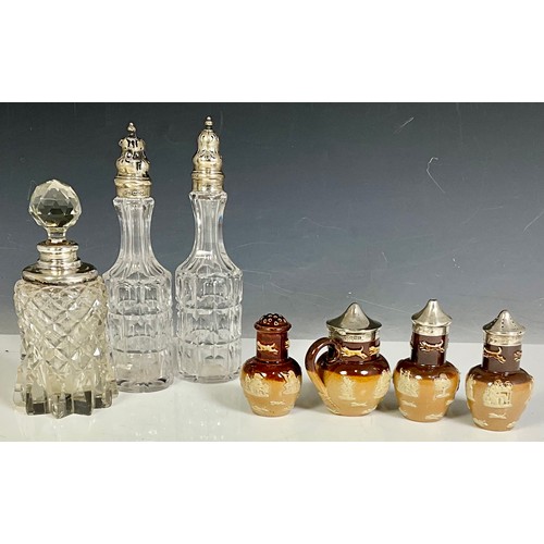 307 - CUT GLASS AND DOULTON LAMBETH CRUETS MOST WITH HALLMARKED SILVER LIDS