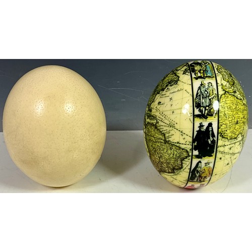 401 - 2 OSTRICH EGGS ONE OF WHICH IS PAINTED WITH A HIGHLY DETAILED MAP OF THE WORLD.