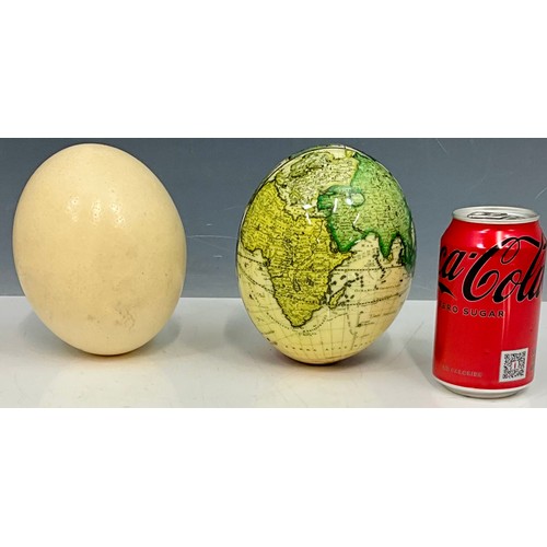 401 - 2 OSTRICH EGGS ONE OF WHICH IS PAINTED WITH A HIGHLY DETAILED MAP OF THE WORLD.