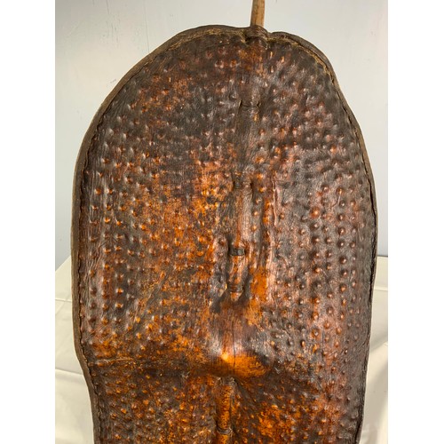 76 - TRADITIONAL TRIBAL SHIELD OF STRETCHED ANIMAL HIDE ON CENTRAL STAFF, POSSIBLY A DINKA / NUER  FROM S... 