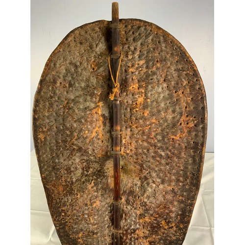 76 - TRADITIONAL TRIBAL SHIELD OF STRETCHED ANIMAL HIDE ON CENTRAL STAFF, POSSIBLY A DINKA / NUER  FROM S... 