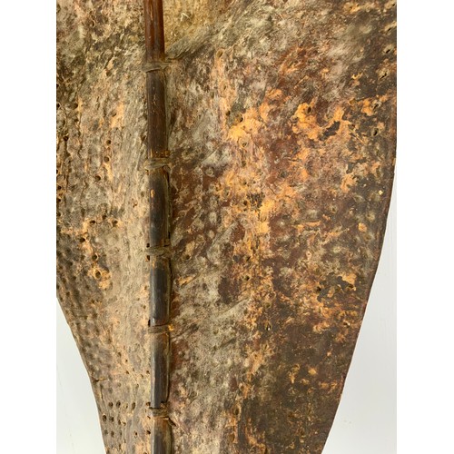 76 - TRADITIONAL TRIBAL SHIELD OF STRETCHED ANIMAL HIDE ON CENTRAL STAFF, POSSIBLY A DINKA / NUER  FROM S... 