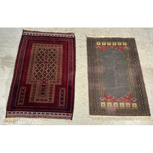 753 - 2 RED GROUND RUGSWITH EASTERN DESIGN LARGEST 134cm x 87cm