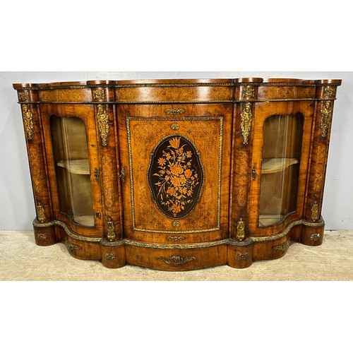 A MAGNIFICENT LATE VICTORIAN WALNUT AND MARQUETRY CREDENZA, THE INLAID WALNUT HAVING GILT METAL MOUNTS AND THE CENTRAL DOOR FEATURES AN OVAL MARQUETRY FLORAL PANEL WIDTH 211cm , 111cm TALL