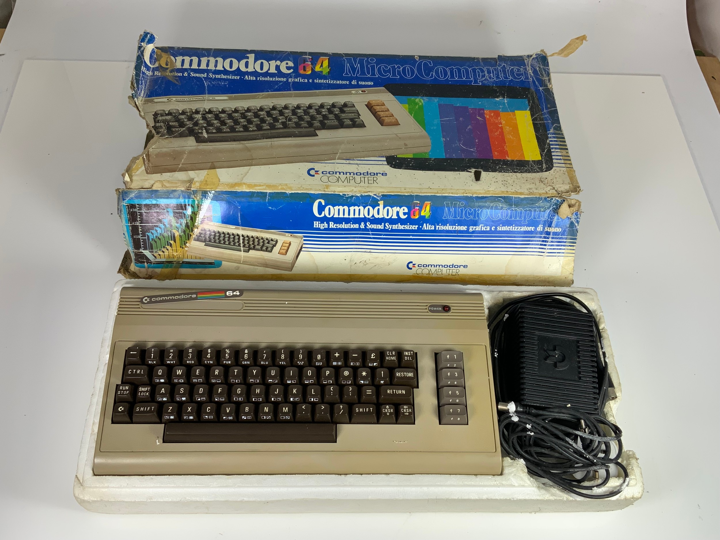 A COMMODORE 64 COMPUTER IN ORIGINAL BOX, (ALTHOUGH WORN AS SHOWN)