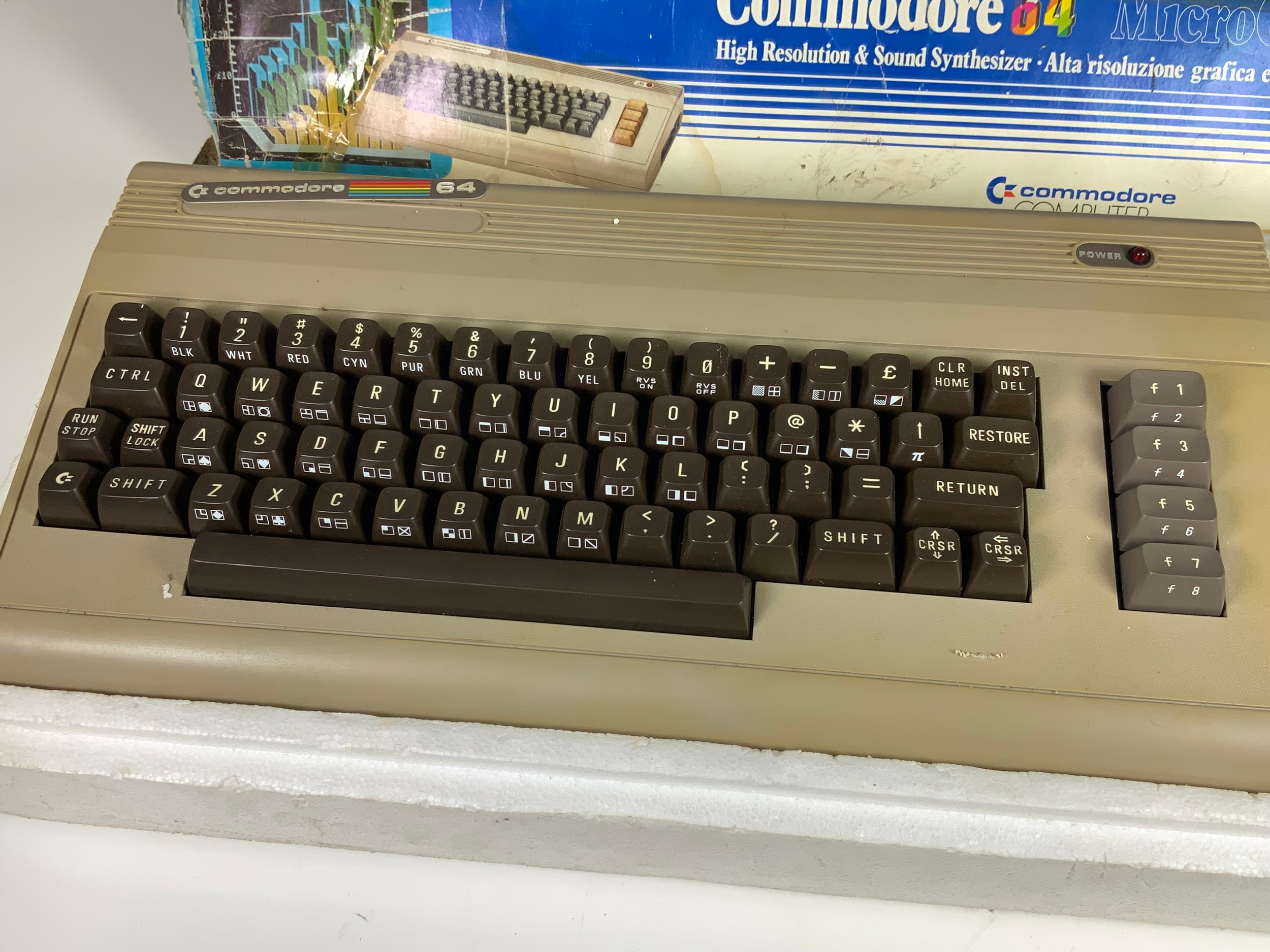A COMMODORE 64 COMPUTER IN ORIGINAL BOX, (ALTHOUGH WORN AS SHOWN)