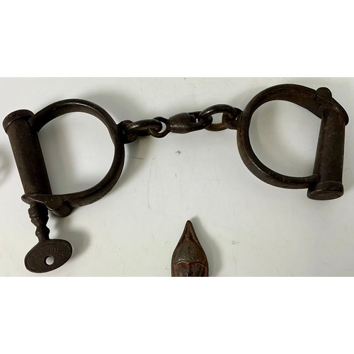PAIR OF VICTORIAN HIATT WARRANTED WROUGHT IRON HANDCUFFS, AN EARLY ...