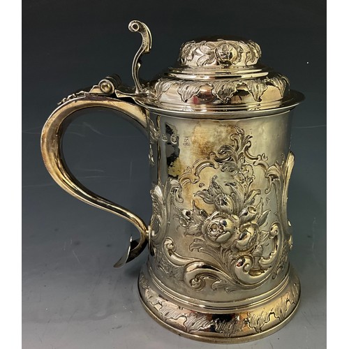 EARLY GEORGE III SILVER TANKARD, REPOUSSÉ FLORAL AND SCROLL DECORATION TO THE BODY AND DOMBED LID, WITH SCROLL HANDLE AND FLARED THUMBPIECE   19.5cm. HALLMARKED LONDON 1761 , ETCHED TO BASE WHISTLER 11 THE STRAND LONDON  808g