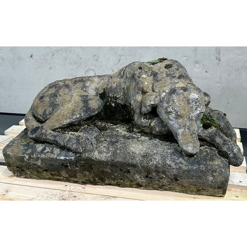 WELL MODELLED / CAST RECONSTITUTED STONE MODEL OF A RECUMBENT HOUND, WELL WEATHERED, APPROXIMATELY 77cm , 48cm and stand 35cm tall, this is one of 2 similar models (option)