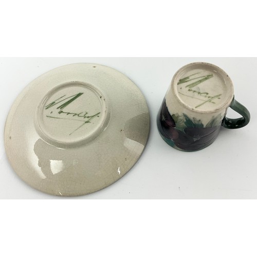 18 - RARE EARLY MOORCROFT POTTERY COFFEE CAN / CUP AND SAUCER DECORATED WITH PANSY PATTERN ON A WHITE  GR... 
