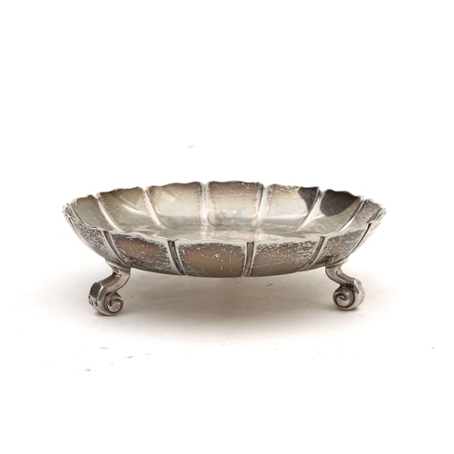 41 - A George V silver strawberry dish and seven Elizabeth II silver napkin ringsthe tripod dish with fol... 