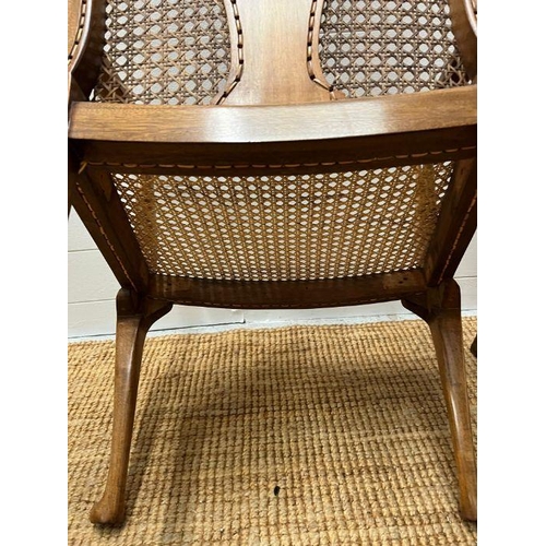 100 - A pair of cane arm chairs with walnut frame (One AF)