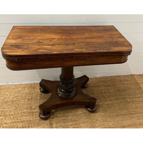 102 - A George IV style card table with rectangular top folding to enclose a blaze on turned column (H74cm... 