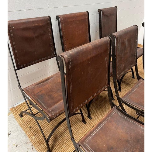 121 - Six wrought iron folding chairs, sling style leather seat and seat back, aged brown leather with dou... 