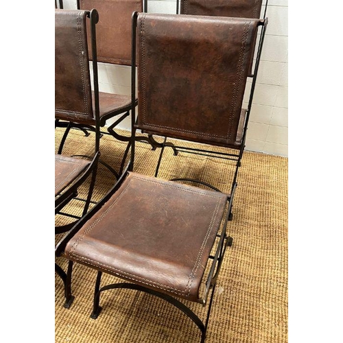 121 - Six wrought iron folding chairs, sling style leather seat and seat back, aged brown leather with dou... 
