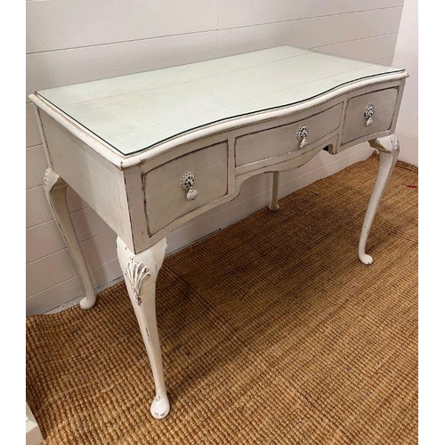 123 - A white painted dressing table with three drawers and cabriole legs (H75cm W98cm D51cm)