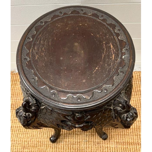 125 - An ebonised plant stand table, carved with leaves and flowers (H73cm)