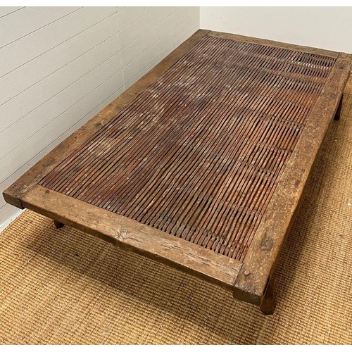 129 - A North African reclaimed panel converted into a large low table or day bed height 38cm and  205X114