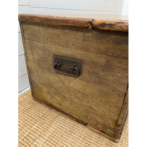 131 - An oak three panelled top trunk with wrought iron handles. (88cm W x 50cm d x 44cm H)