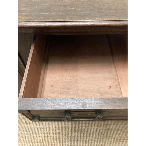 134 - An Arts and Crafts style sideboard, two central drawers flanked by cupboards on square turned feet (... 