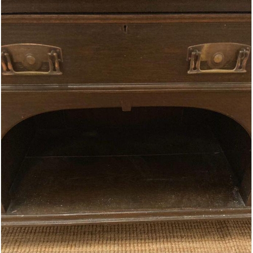 134 - An Arts and Crafts style sideboard, two central drawers flanked by cupboards on square turned feet (... 